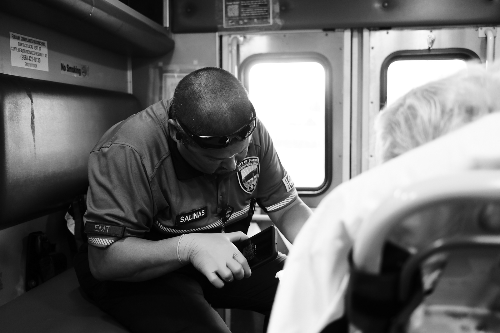He uses is phone light to find a vein to place an IV.