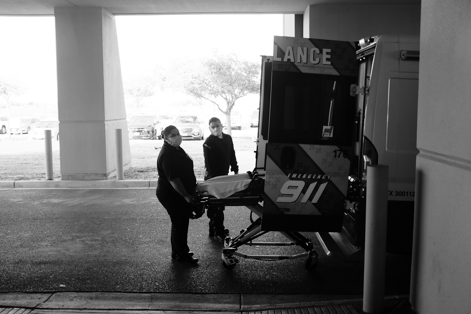 After cleaning the stretcher, they're loading the stretcher back into the unit to eventually get back into service.