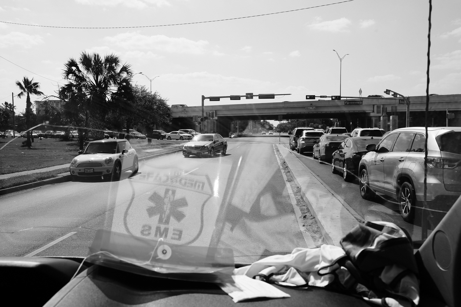 In this situation, we are activated, lights and sirens, prior to coming up to a crowded intersection. No other option but to use the opposite lane; less of a mess and danger to everyone. These are some of the things we must consider as EMTs and Paramedics. This is the reason why you stop despite the road having a median. It's one less hazard to factor in when responding to an emergency. There are many factors to consider.  Lights/Sirens on = you stop or pull to your right.