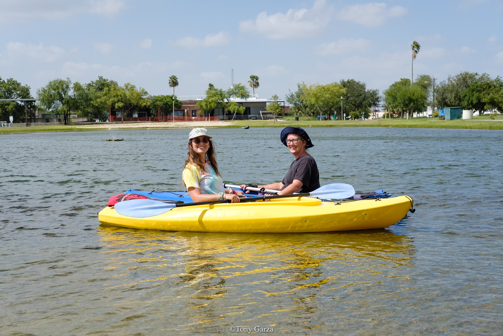 Mother and daughter kayak on a lake, McAllen, Texas, July 2020.