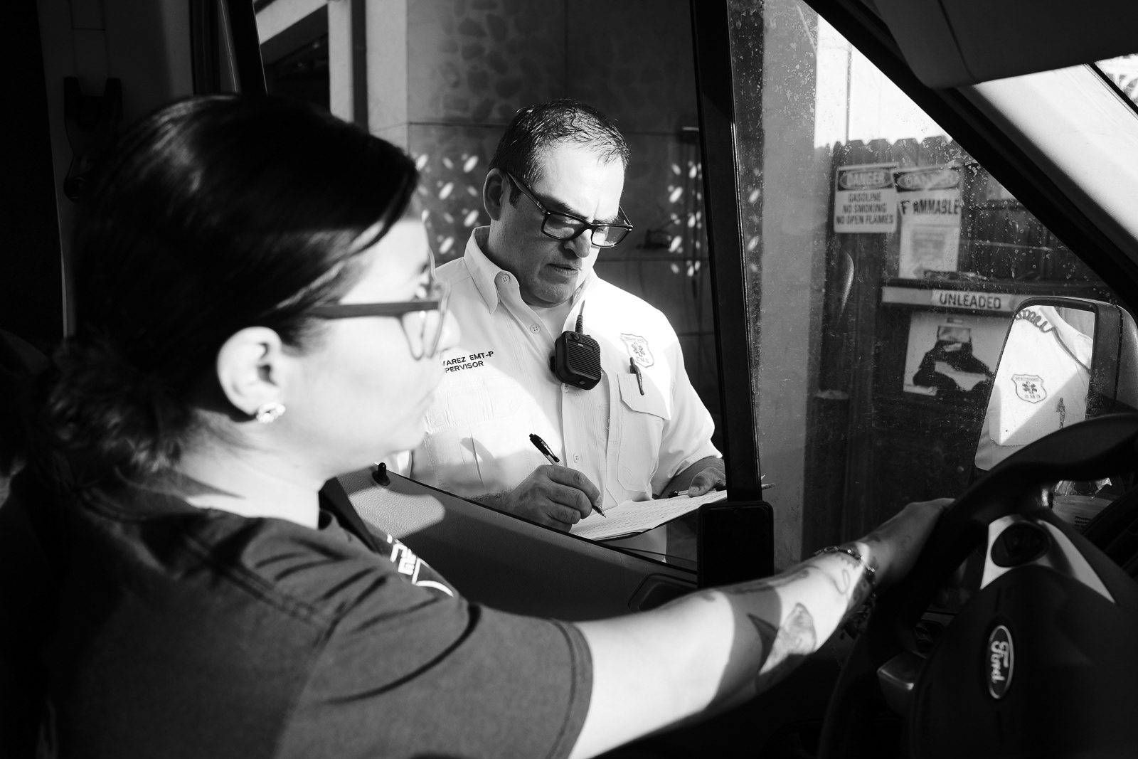 Paramedic and Supervisor Felipe checking the miles of each unit requiring fuel before fueling.