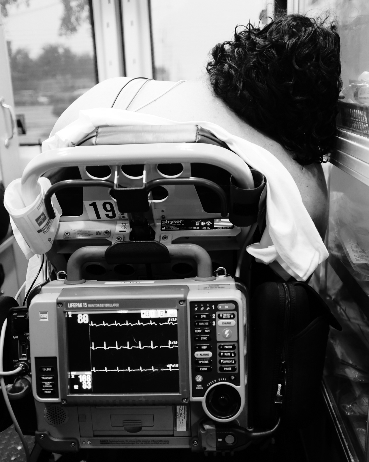 On the way to the hospital, patient resting their head on the cabinet.