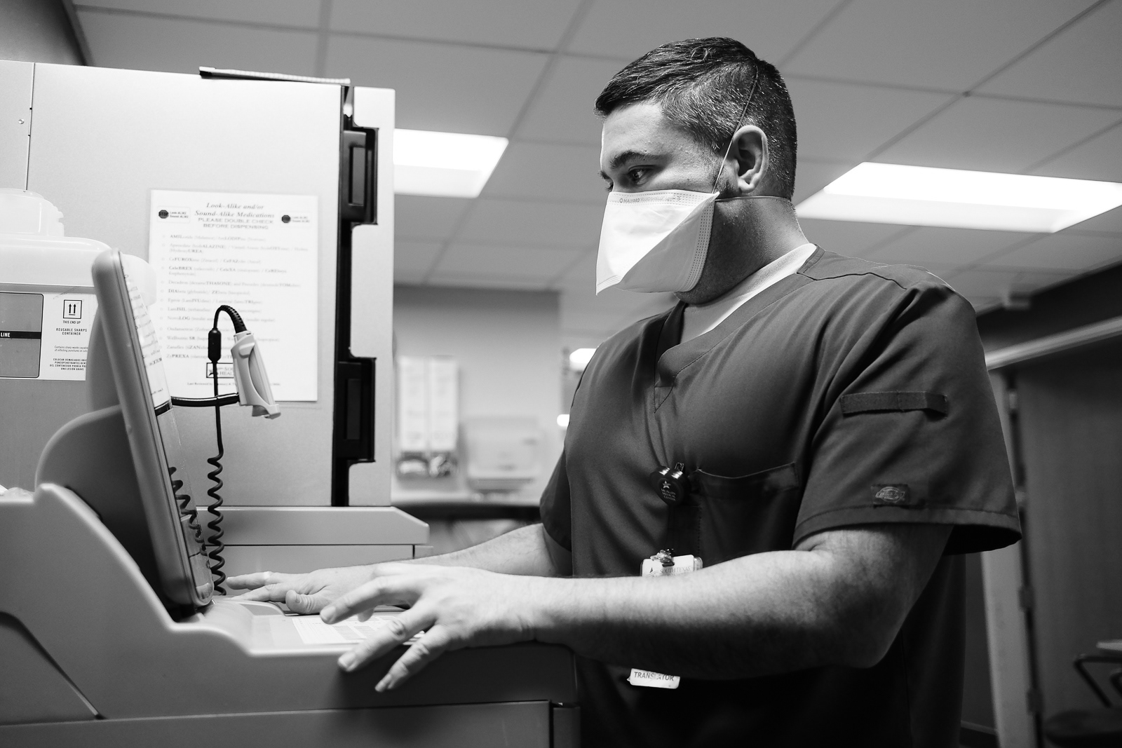 Leo, Paramedic and E.R. Nurse, signing out medications from the medication box for a patient.