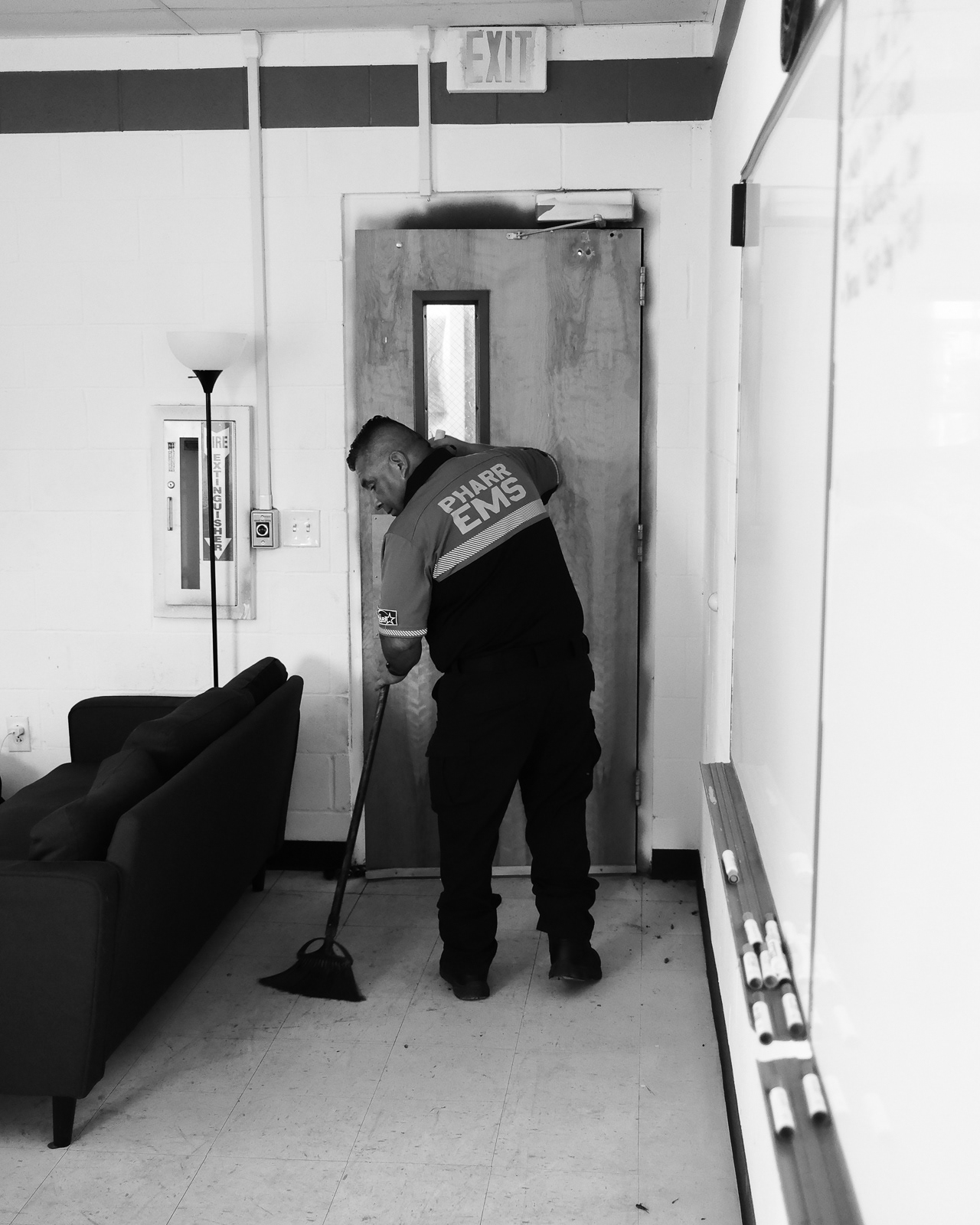 Advance-EMT J. Pena sweeps the floors of the Sullivan Fire Department station that also houses Pharr EMS personnel.