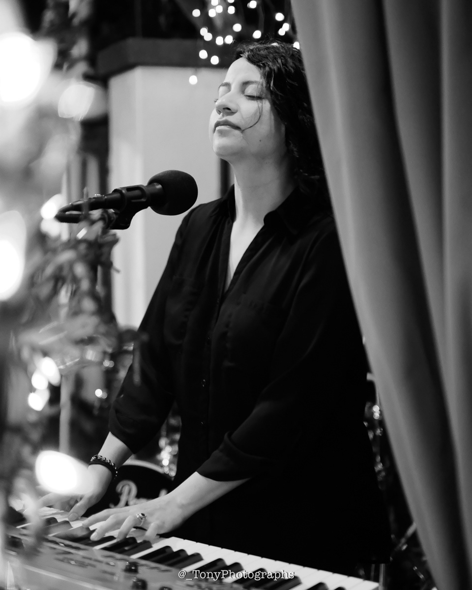 Elisa De Hoyos playing piano at a local restaurant 