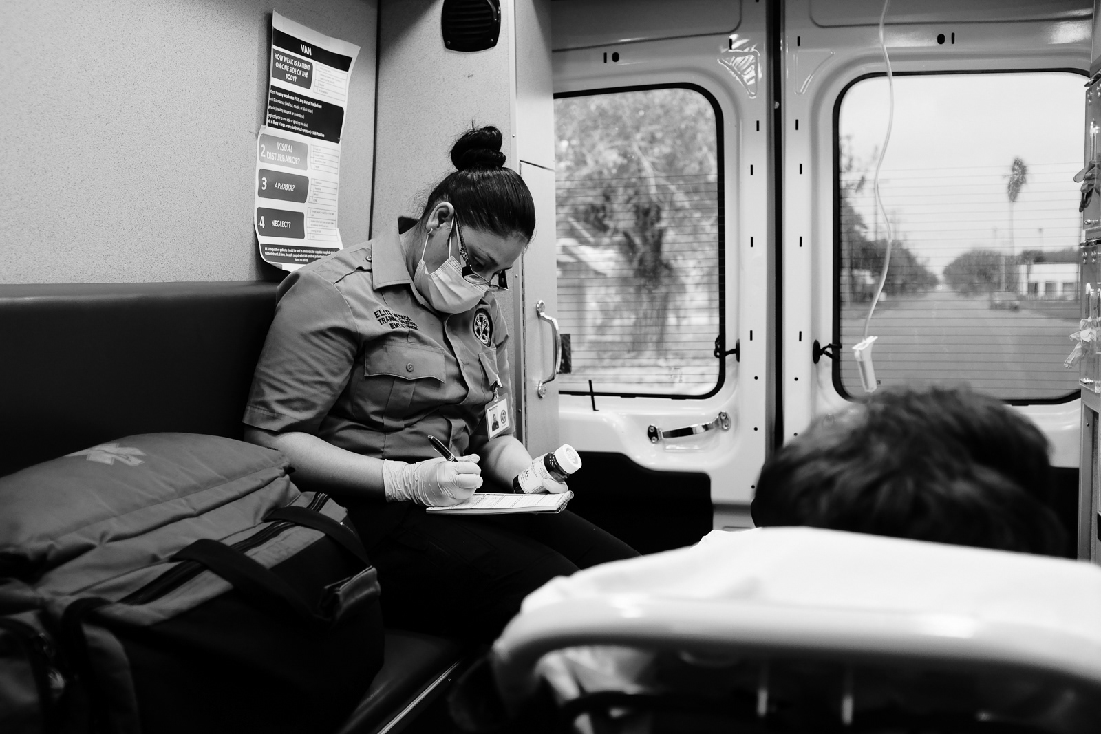 M. Herrera, EMT Student, on her second ride out, checking the patient’s medication on the way to the hospital.