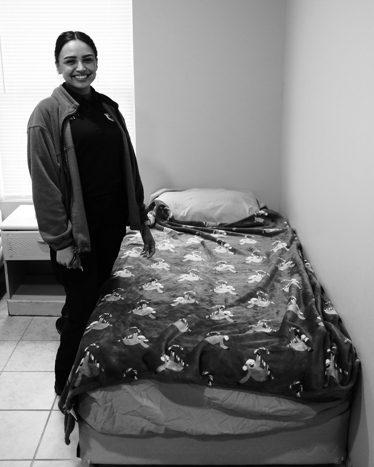 She picks and prepares her bed, hours before seeing the station tonight. In hope that sleep is possible. Yes, thats a sloth blanket.