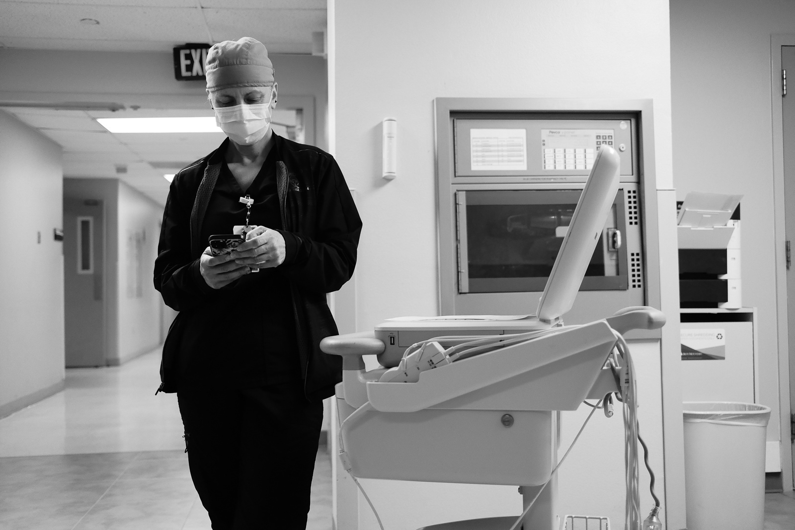 Respiratory tech waiting with an EKG machine for a patient to arrive to their room.