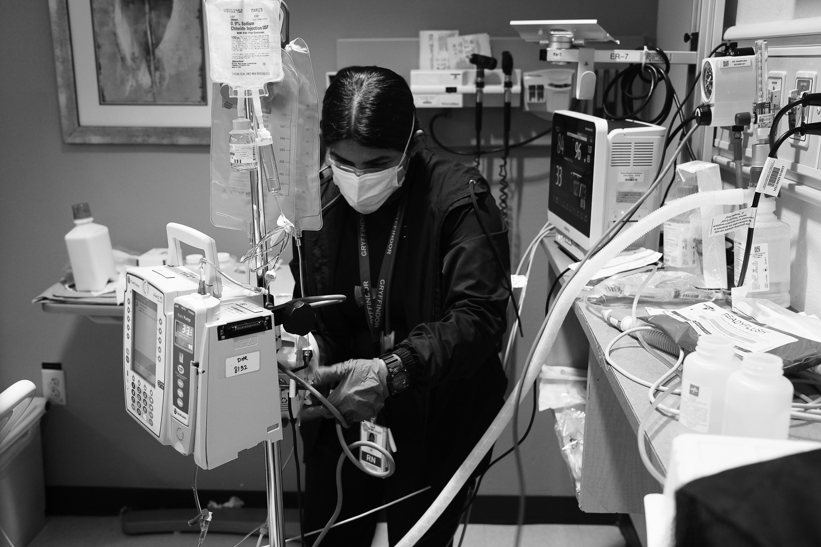Nurse Pam sets up feeding tubes for a critical patient.