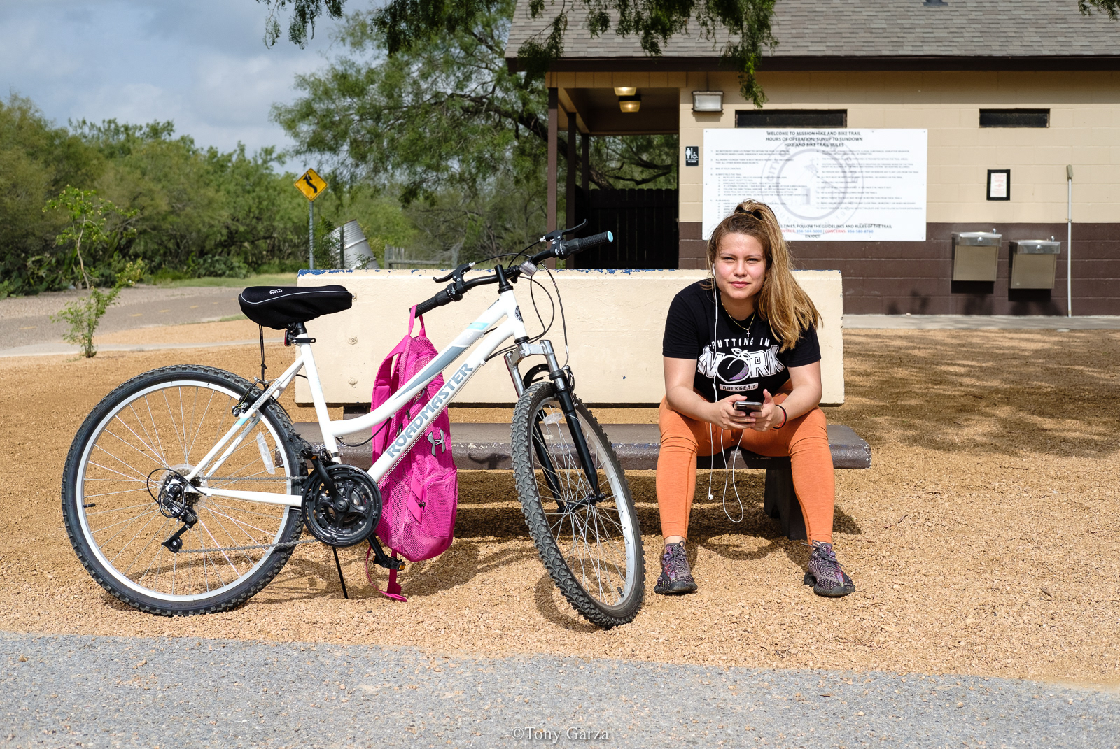 A young woman works out after riding her bike at the hike and bike trails, Mission, Texas, June 2020.