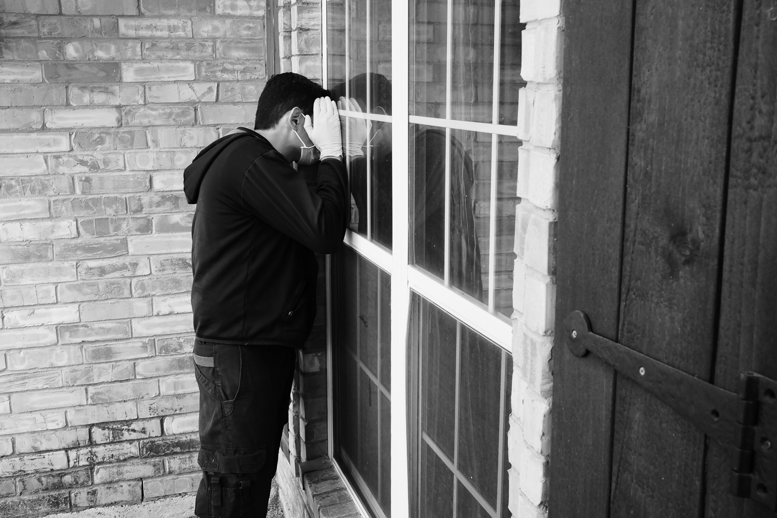 No one answers the door, he tries to see through the window for the patient or someone.