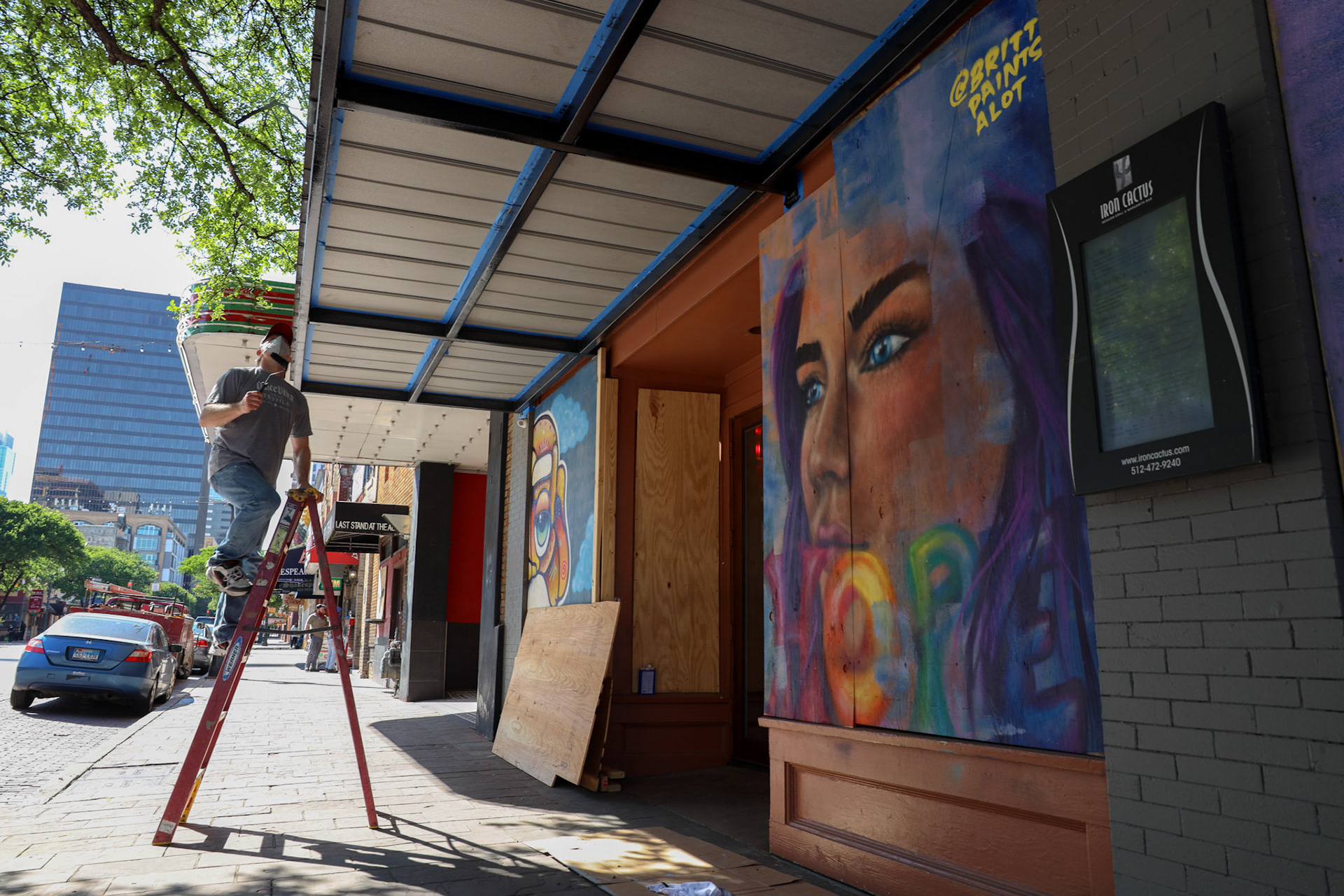 Murals in front of the Iron Cactus restaurant on East Sixth Street.