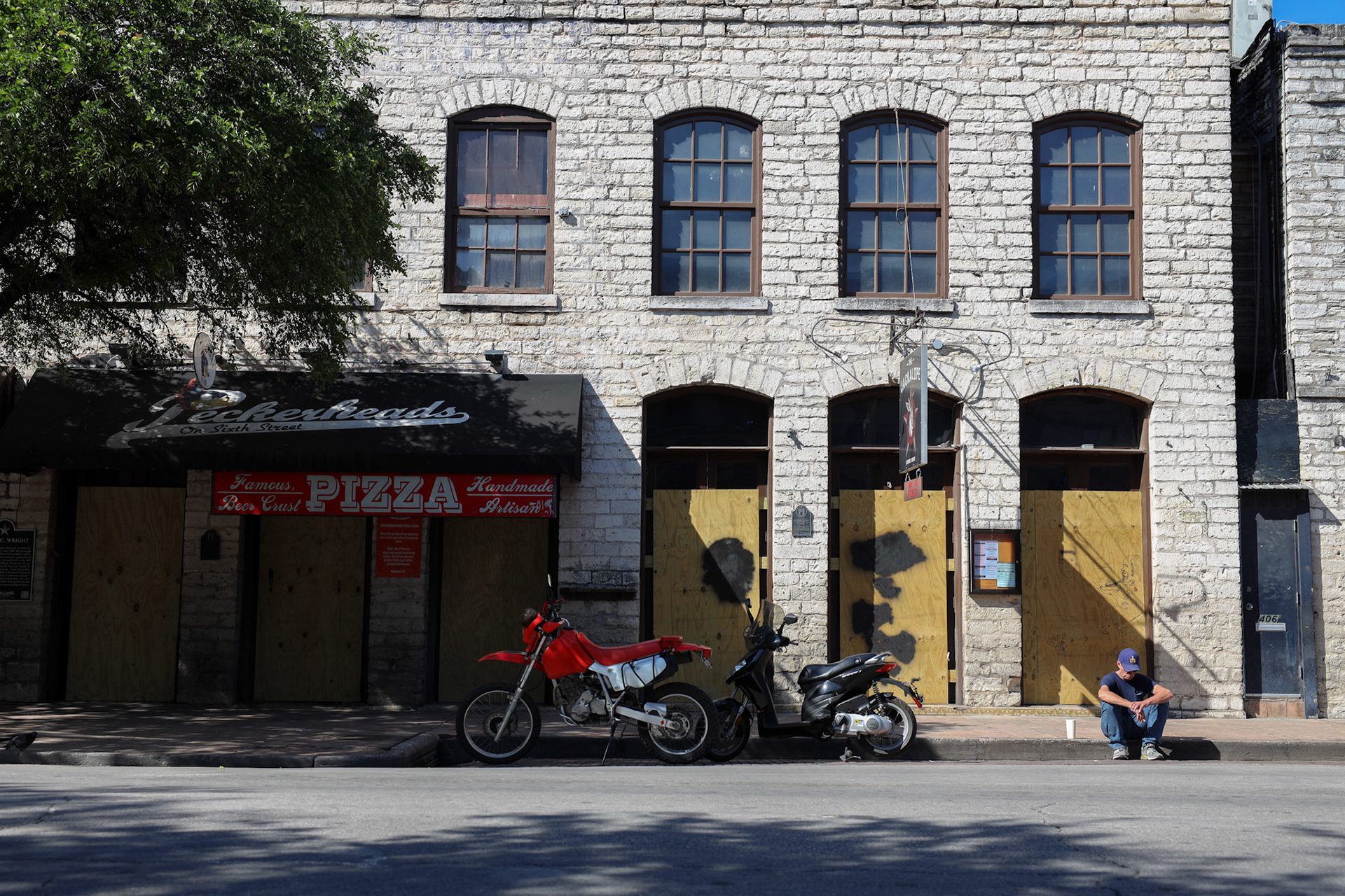 Businesses along famous Dirty Sixth were closed and boarded up. Some workers still go downtown to work and provide takeout from operating restaurants.