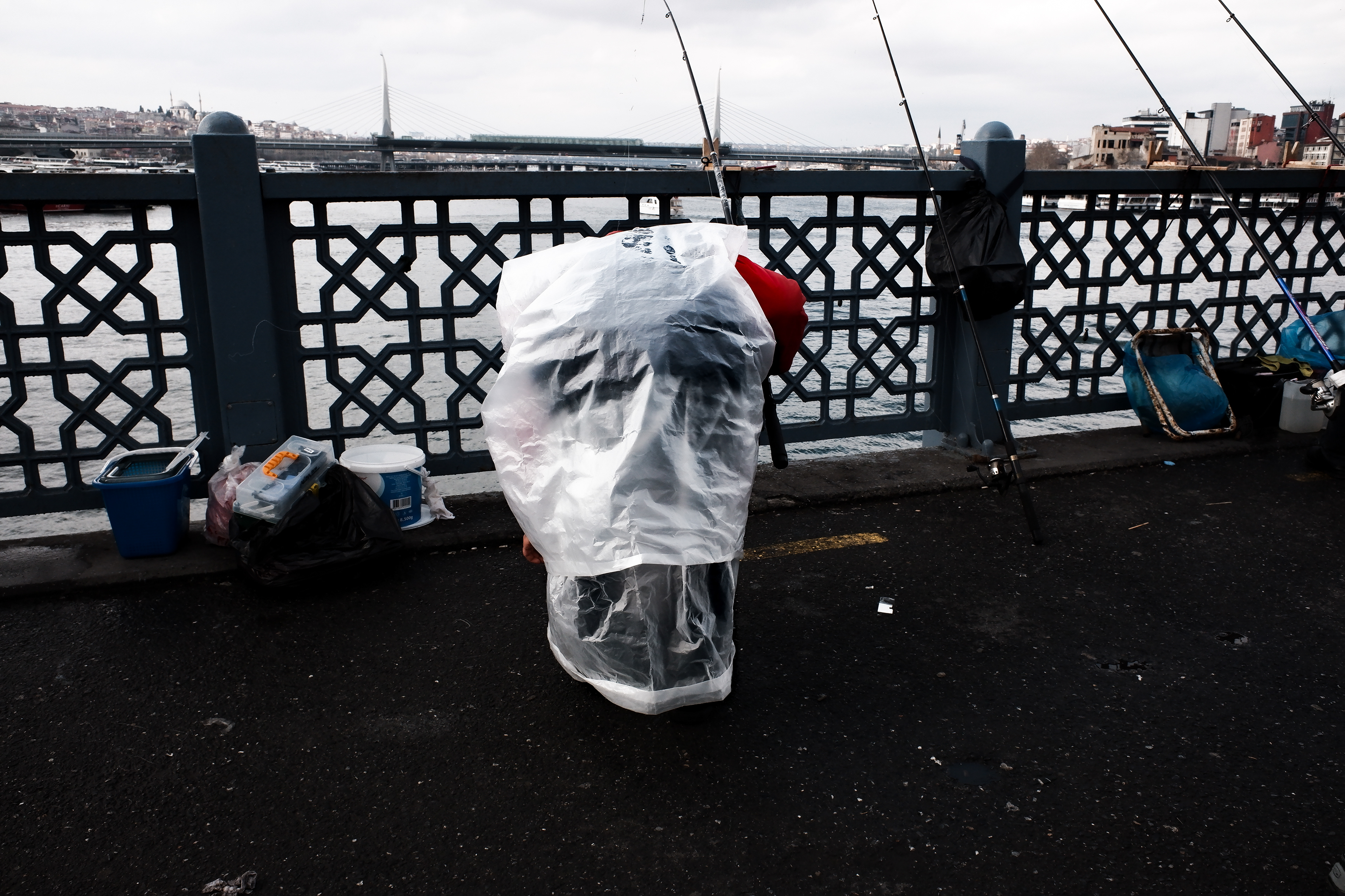 JUXTANBUL CANDID - Taken in Galata Bridge/Istanbul - skull - rain coat - juxtaposition