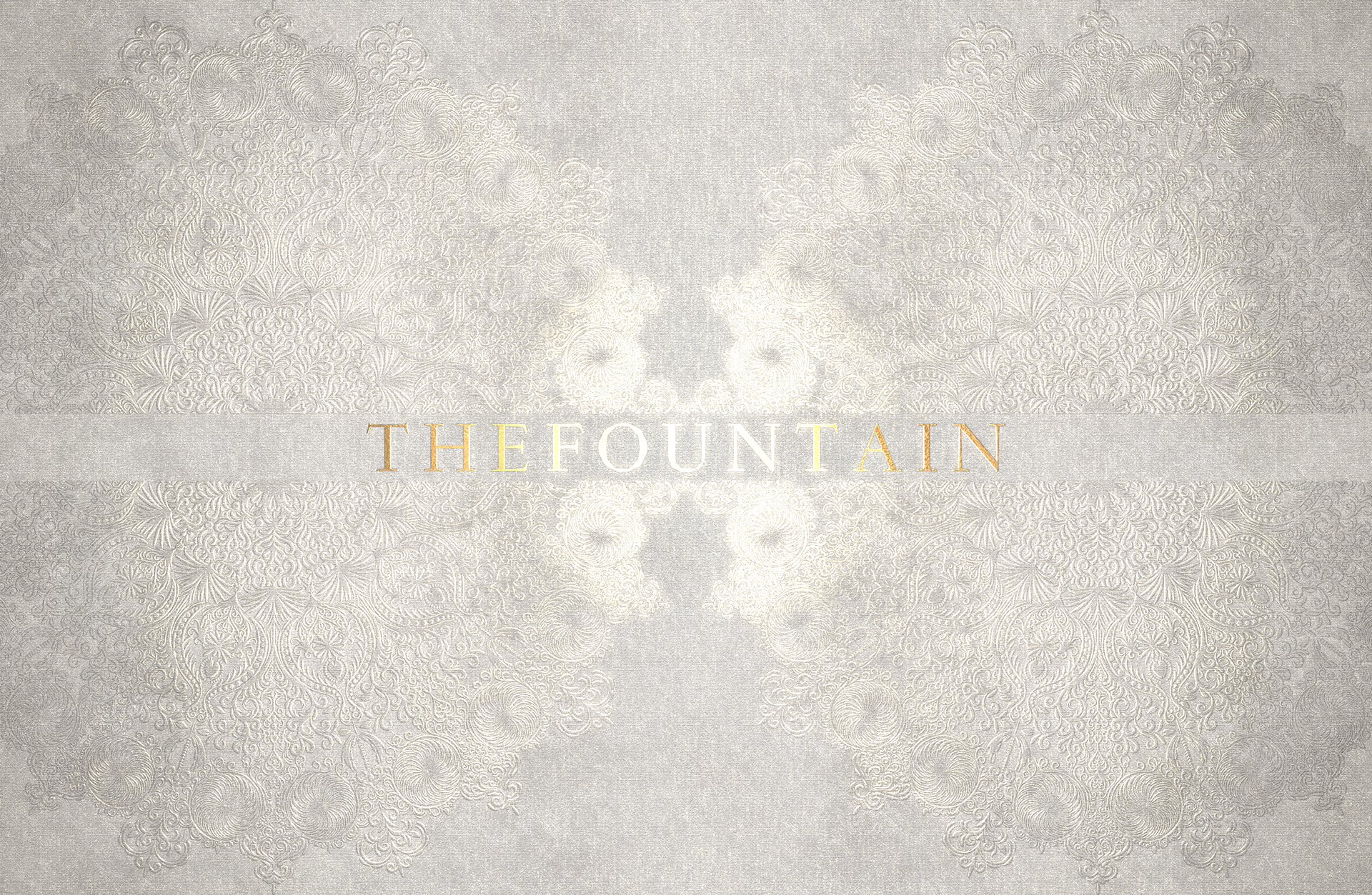 Business card with blind debossed rosace pattern on a luminous grey paper texture.