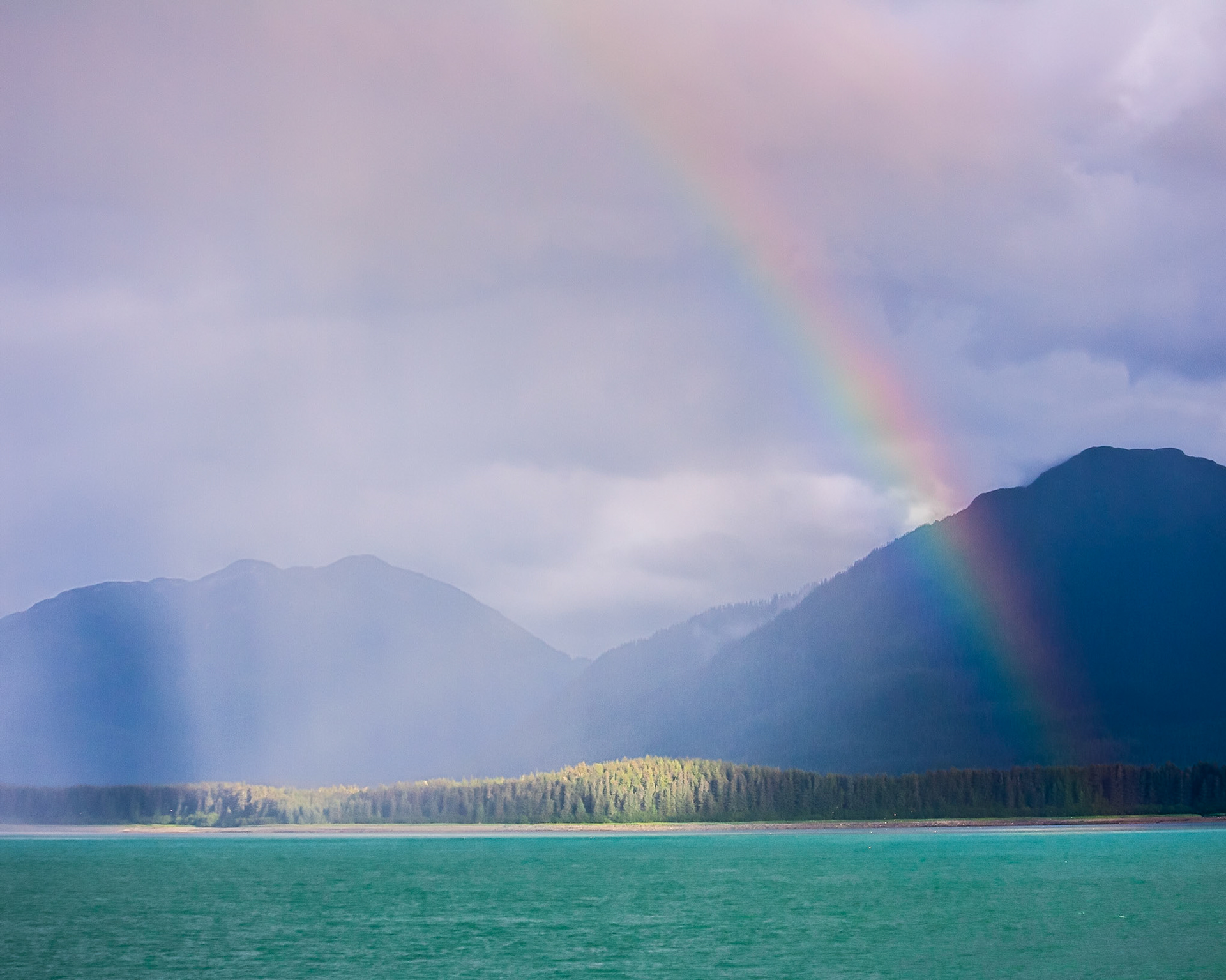 A rainbow appears off the coast of Baranoff Island in Southeast Alaska, USA.
