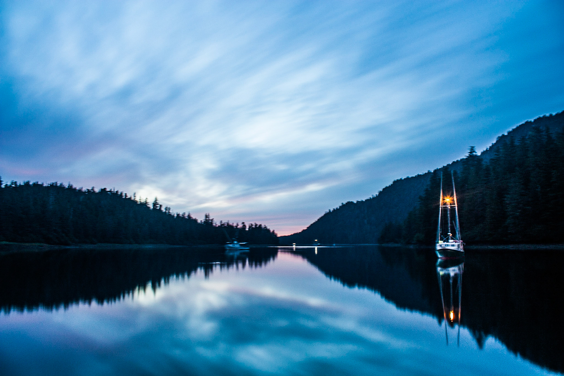 Awhile ago I was working on a couple of boats and a barge up in Alaska. There were many times where I wanted to take a photograph, but I could not due to movement of the boat. When I took this photograph, we were anchored down in the harbor. At this time also, the tidal currents and winds were pretty minimal.Photo was taken in Gedney Harbor, Alaska during blue hour.