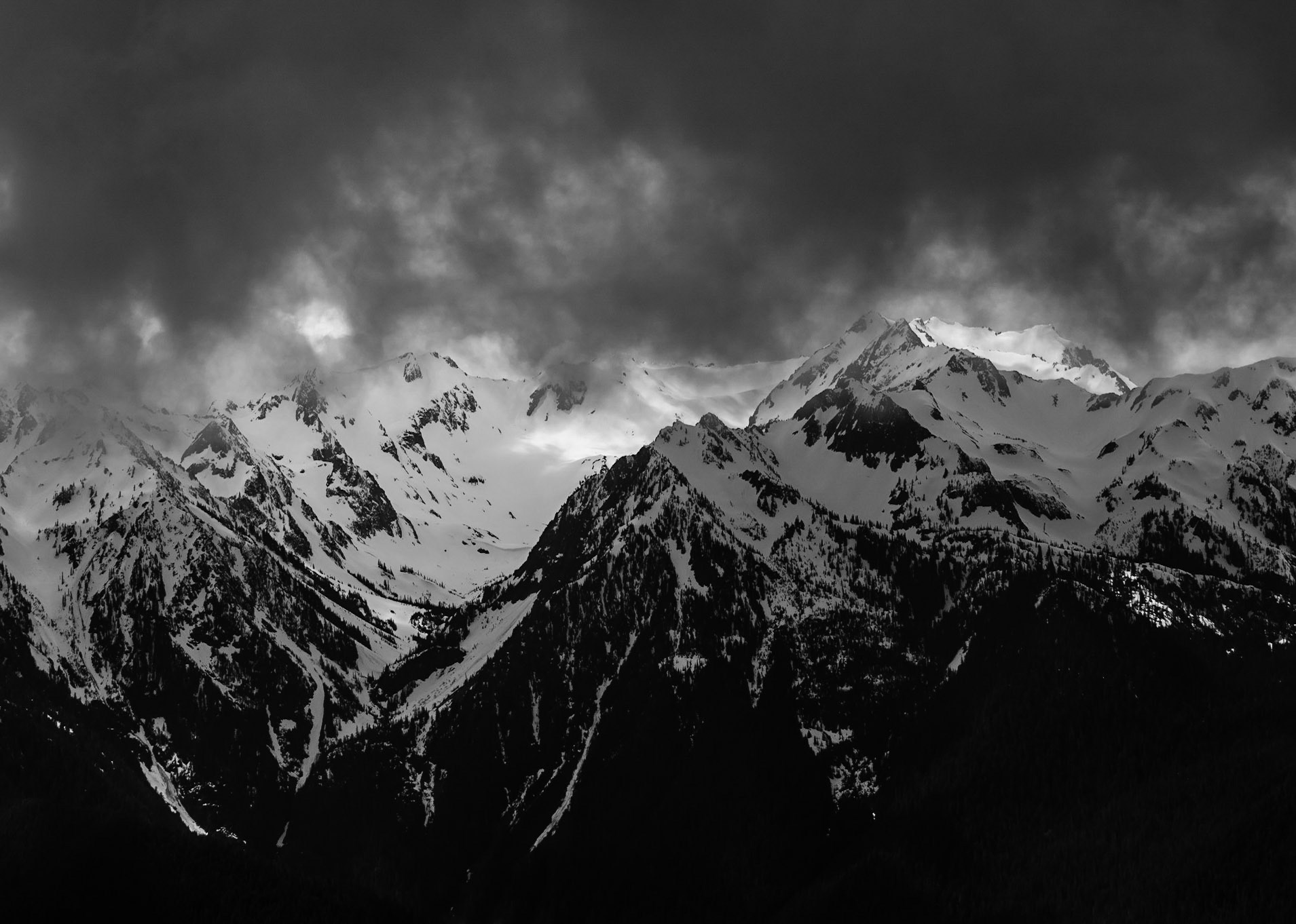 Dark clouds begin to cover the Olympic Mountains.