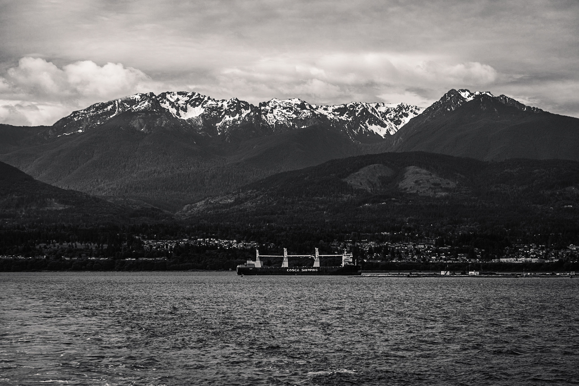 View of the Olympic Mountains from onboard a ferry.