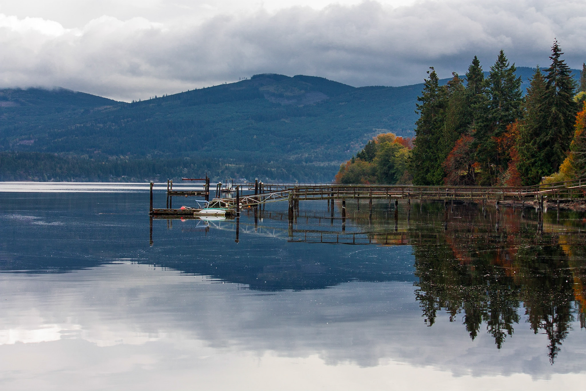 The ocean becomes still as the clouds roll in.