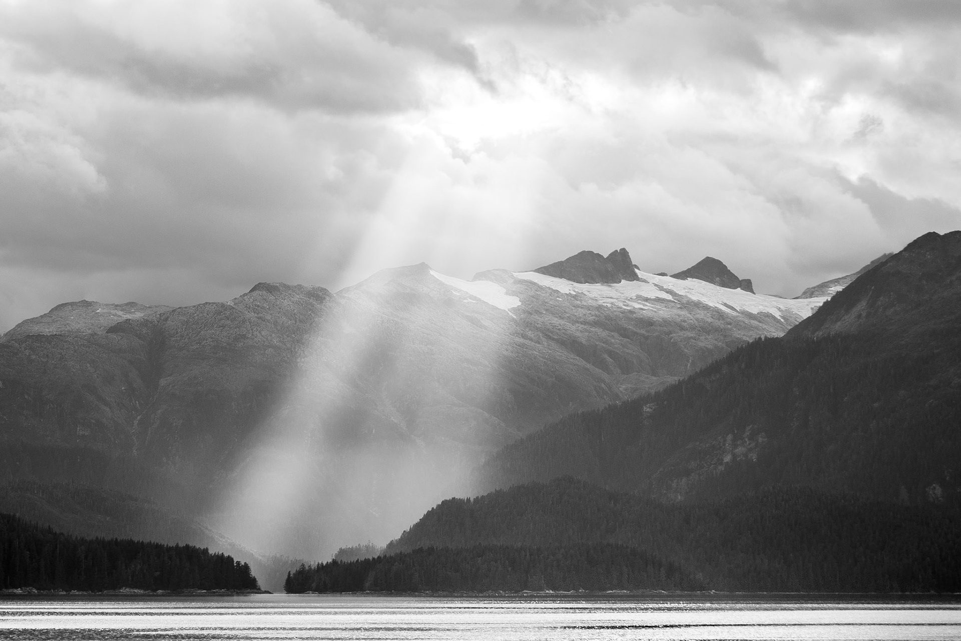 Sunrays illuminate a cove on Baranof Island, AK