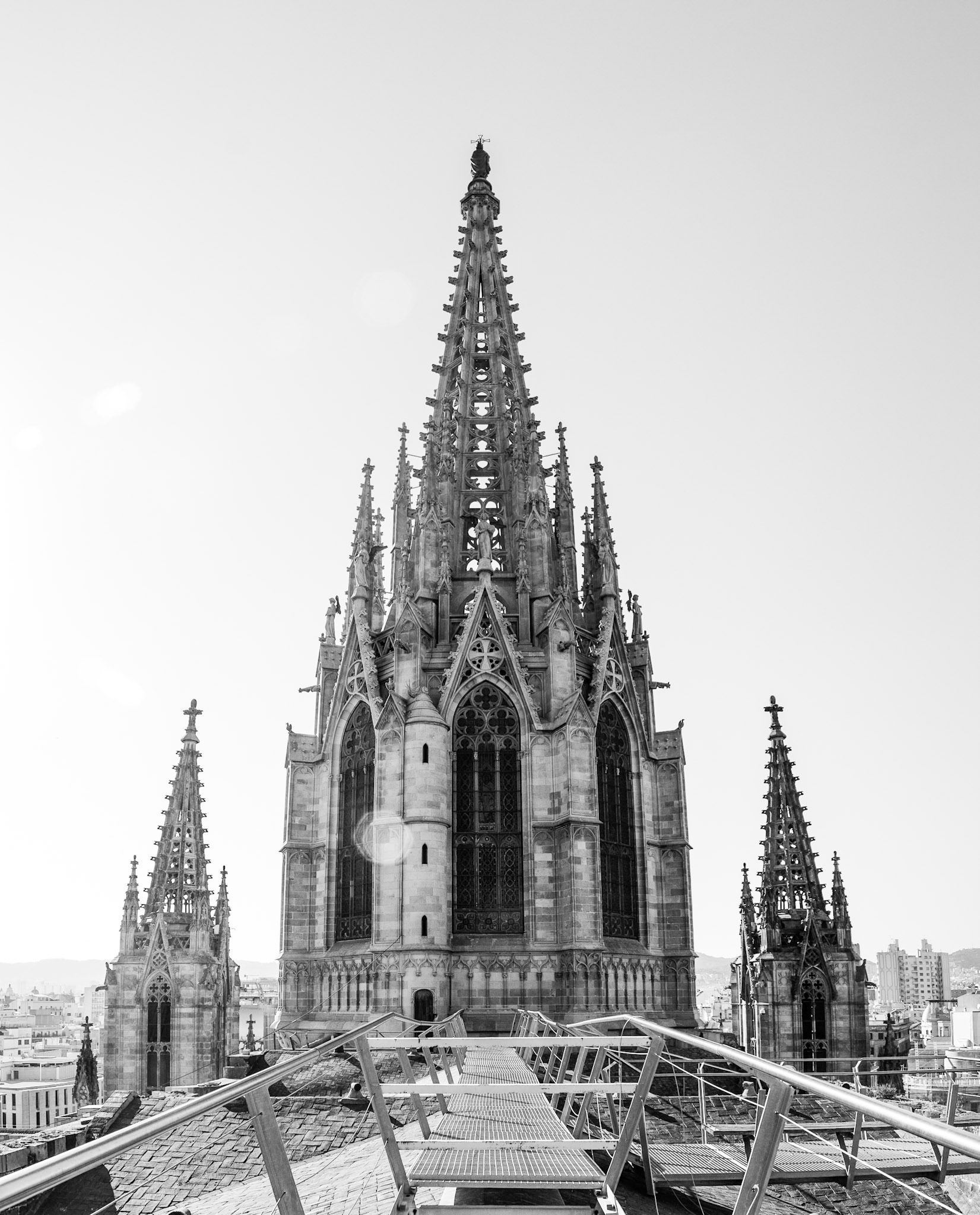 These spires are located on the rooftop of the Cathedral of the Holy Cross and Saint Eulalia, otherwise known as the Barcelona Cathedral. The cathedral is located in the Gothic Quarter of Barcelona, Spain. It dates back to 1519.