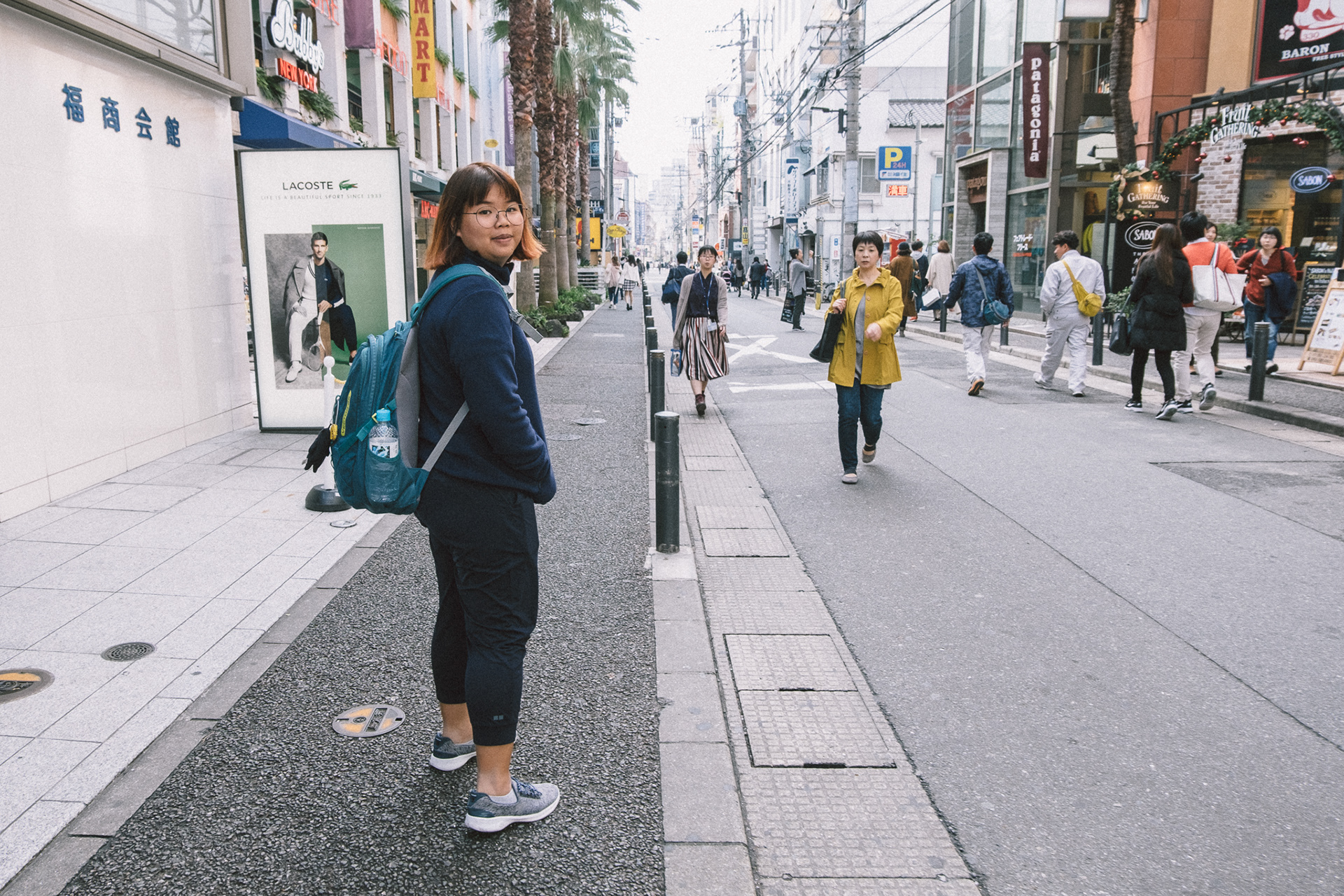 My female friend is walking in the city.