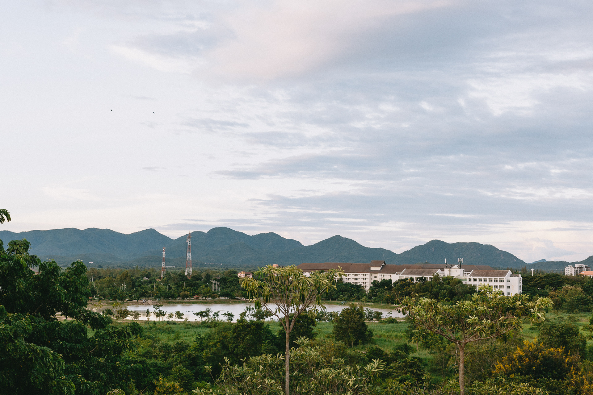 The atmosphere of the university where you can see the dormitory and water basin from a high angle.