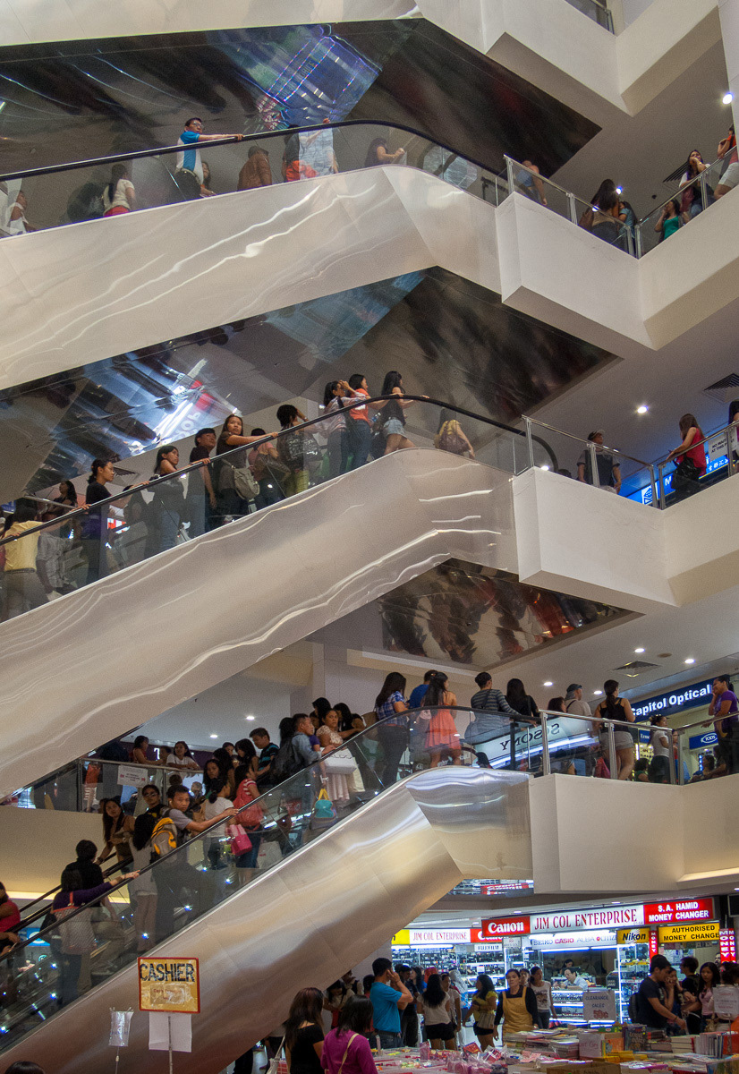 Crowds on escalators in In Lucky Plaza, Orchard Road, Singapore, 2013