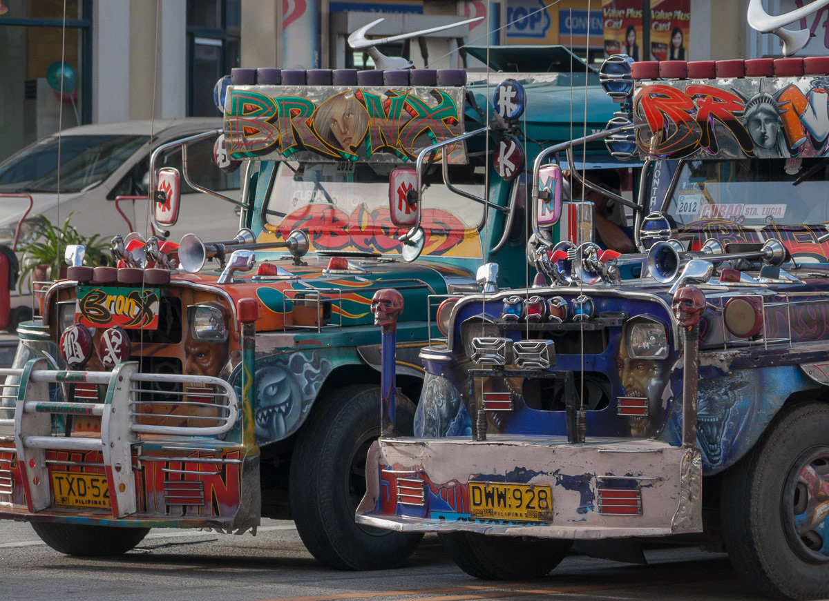 Two colourful and well decorated jeepneys in Marikina, Philippines, 2013