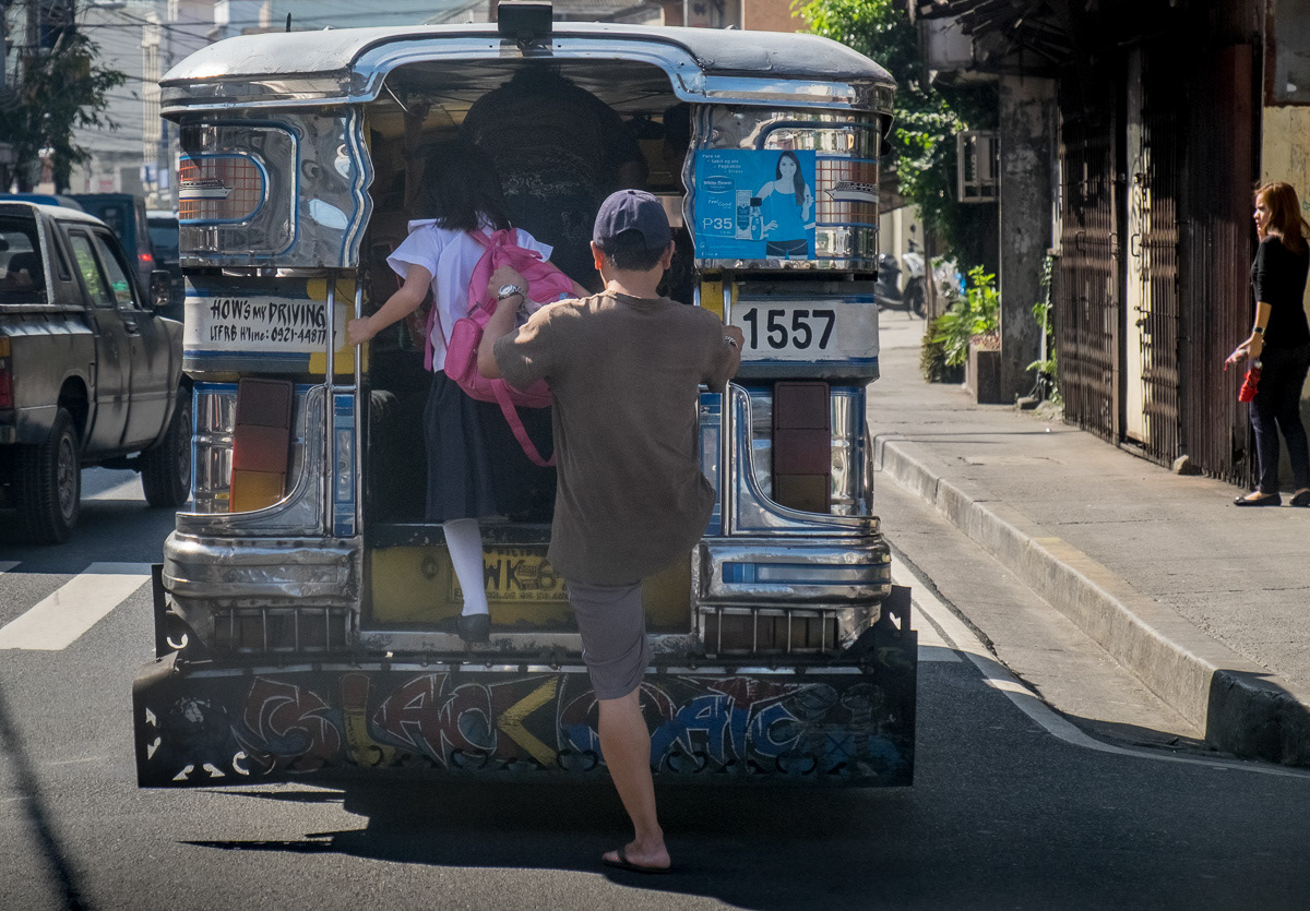 Passengers boarding through rear of a jeepney in Marikina, Philippines, 2015
