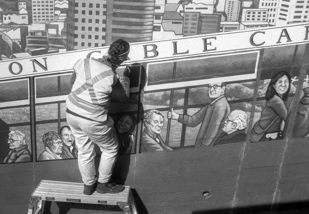 Artist working on Cable Car mural, Wellington, 2016