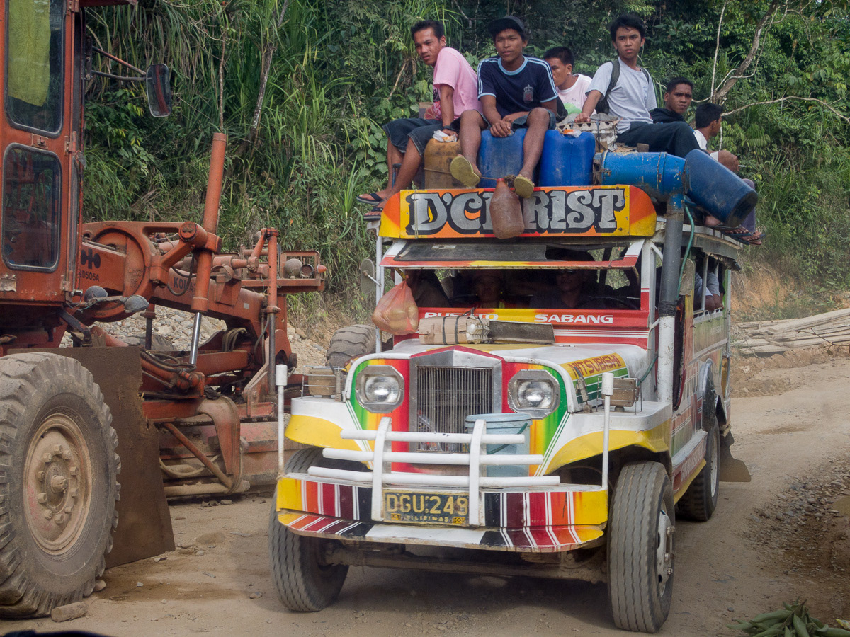 Passengers with produce on roof of jeepney in rural Palawan, Philippines, 2009