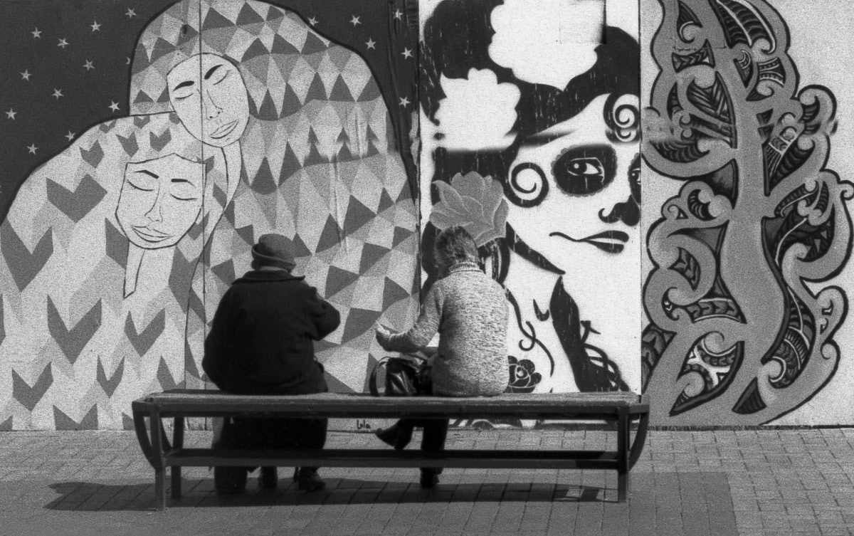 Women sitting on bench beside mural in Church Street, Masterton, 2016