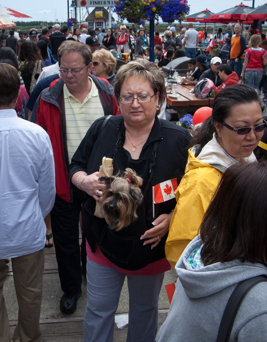 Lady carrying small dog at the Steveston Salmon Festival, Canada Day, 2011