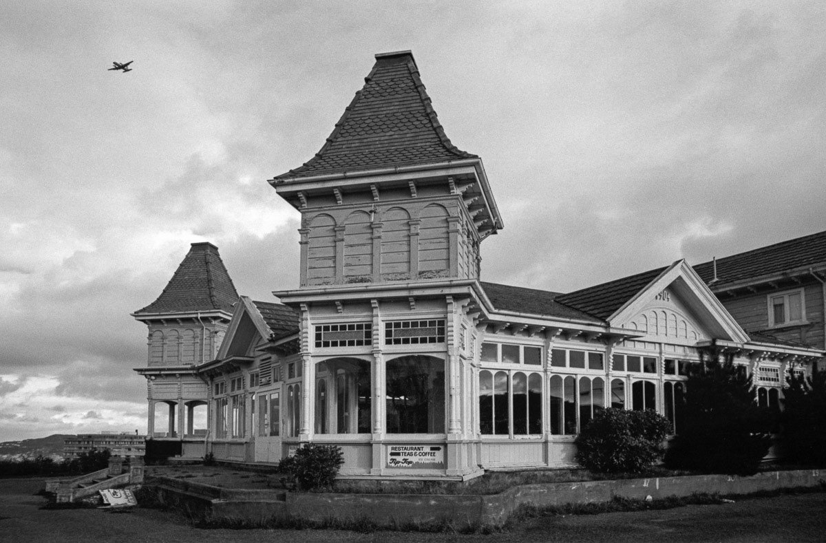 Old tearooms at Kelburn, Wellington, with plane flying overhead, 1978