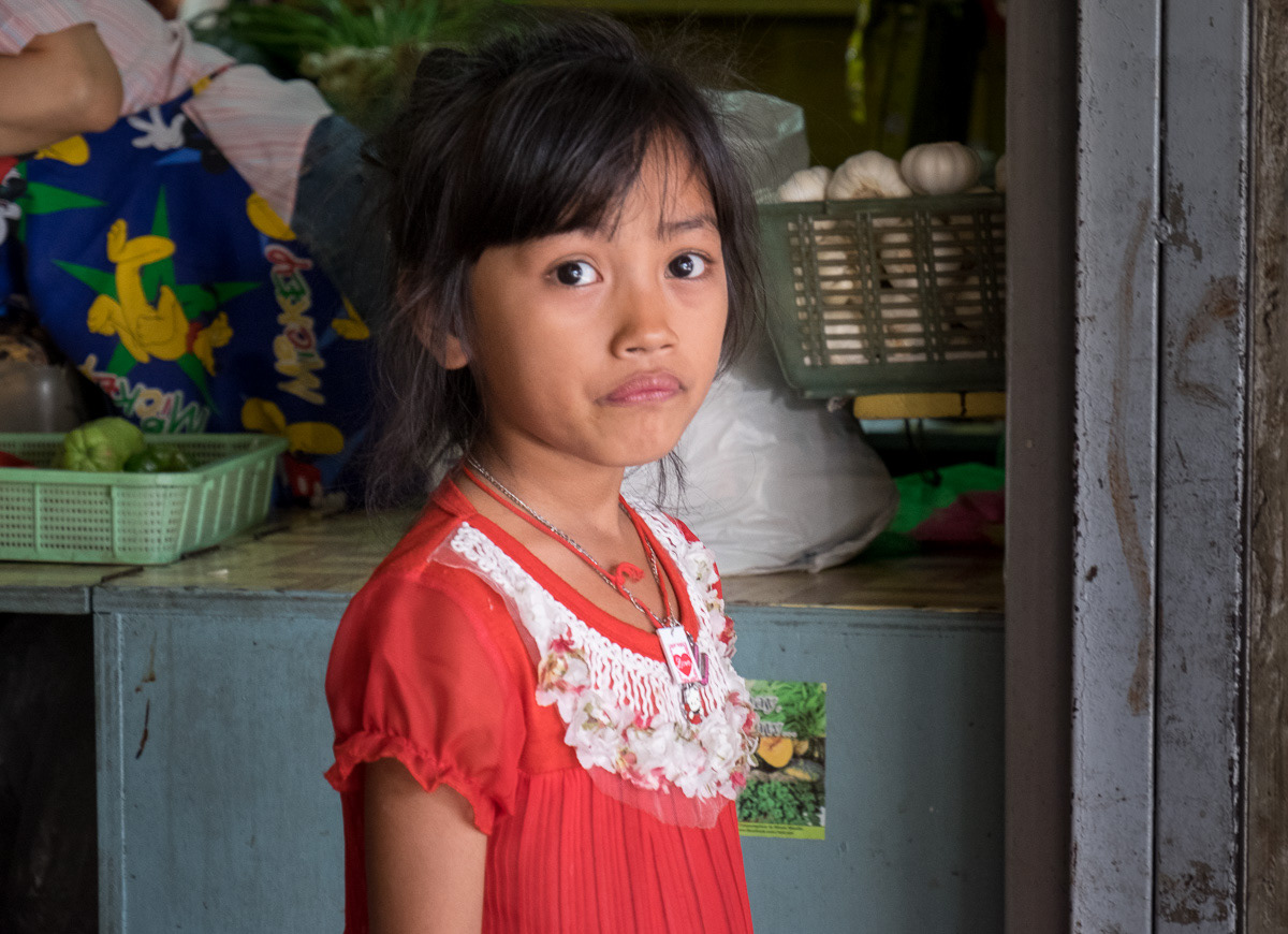 Young girl in red dream, Marikina Markets, Philippines, 2015