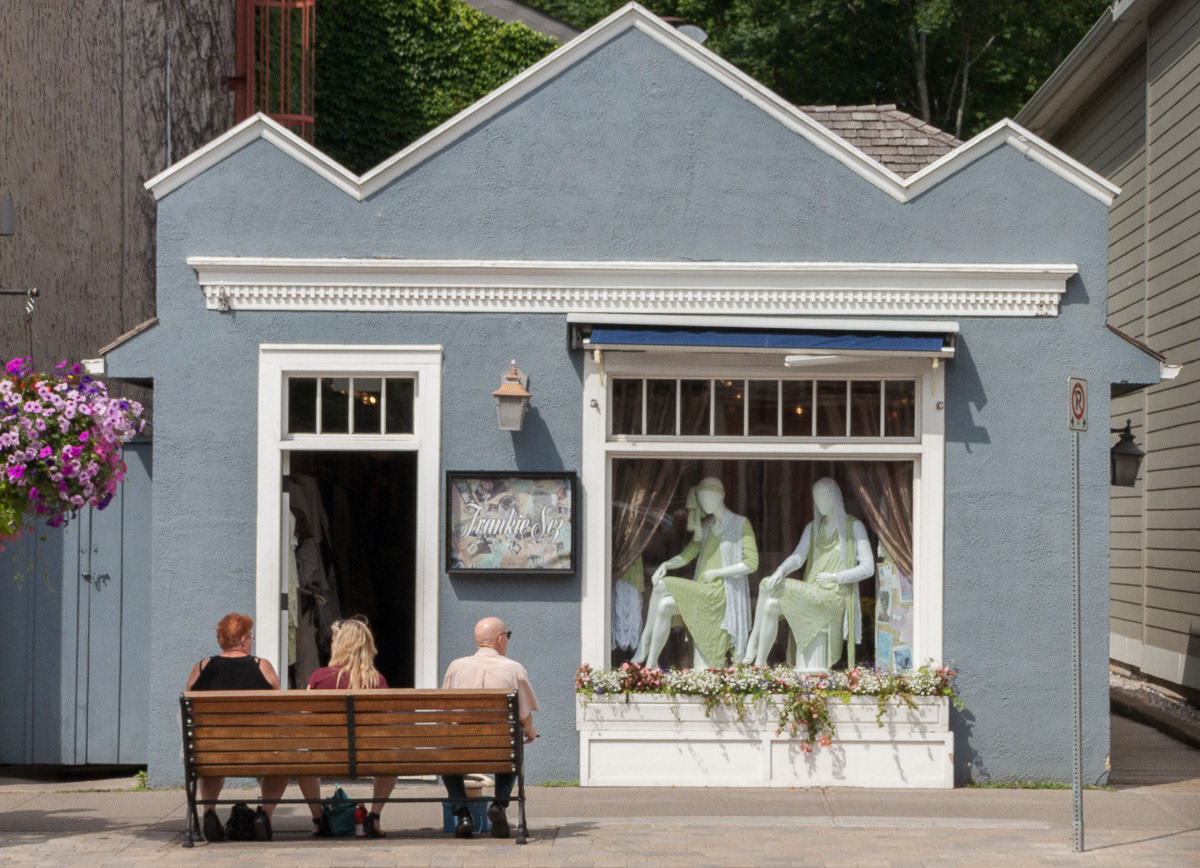 Tourists sitting on bench outside shop at Niagara on the Lake, 2011