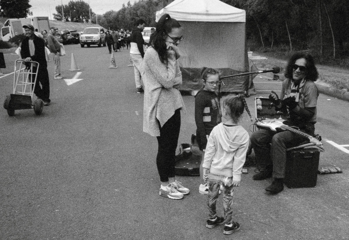 Busker with guitar and admirers, Riverbank market, Lower Hutt, 2016