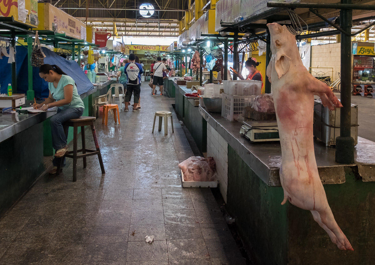 Butchered pig hanging in meat section of Marikina Markets, Philippines, 2015