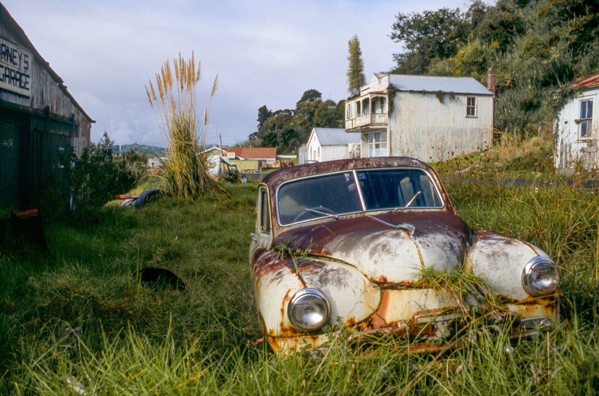 Old Phase 2 Vanguard car lieing in the grass at Kohukohu, Hokianga Harbour, 1986