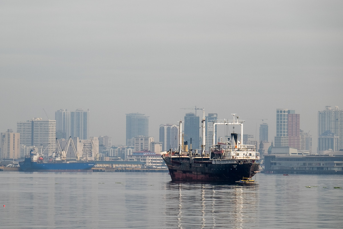 Small ship on Manila Bay with city beyond, 2015