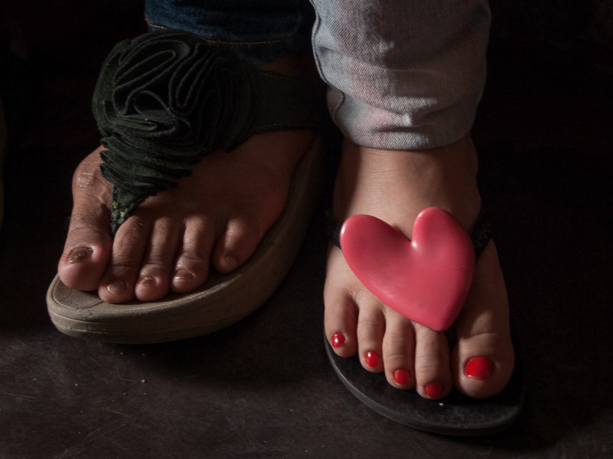 About two feet below, passengers feet in a jeepney, Marikina, Philippines, 2013