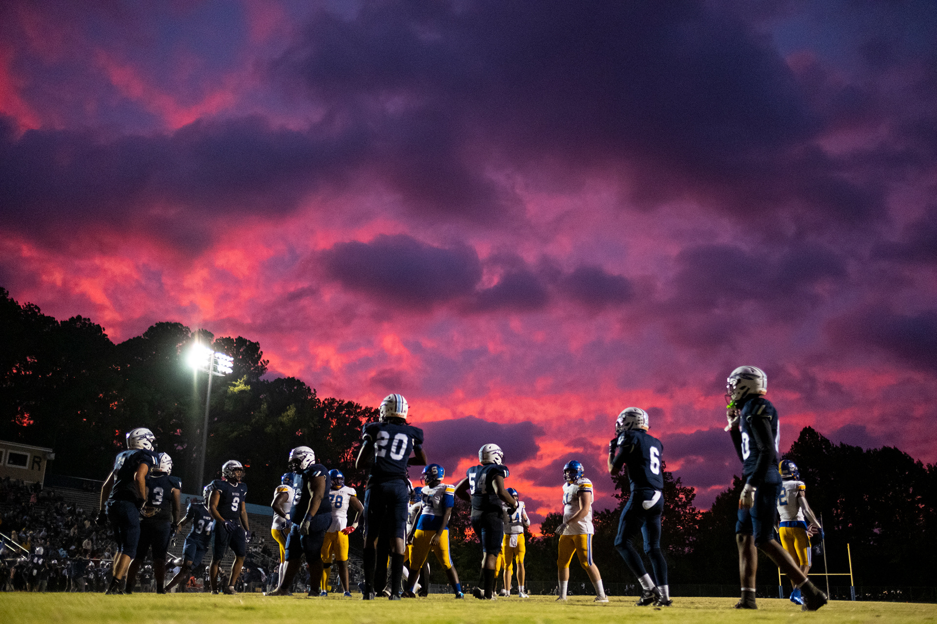 The sun sets over James Frye stadium at Indian River High School in Chesapeake, Virginia on Sept. 29, 2022. Hurricane Ian brought severe weather to many parts of the East Coast.