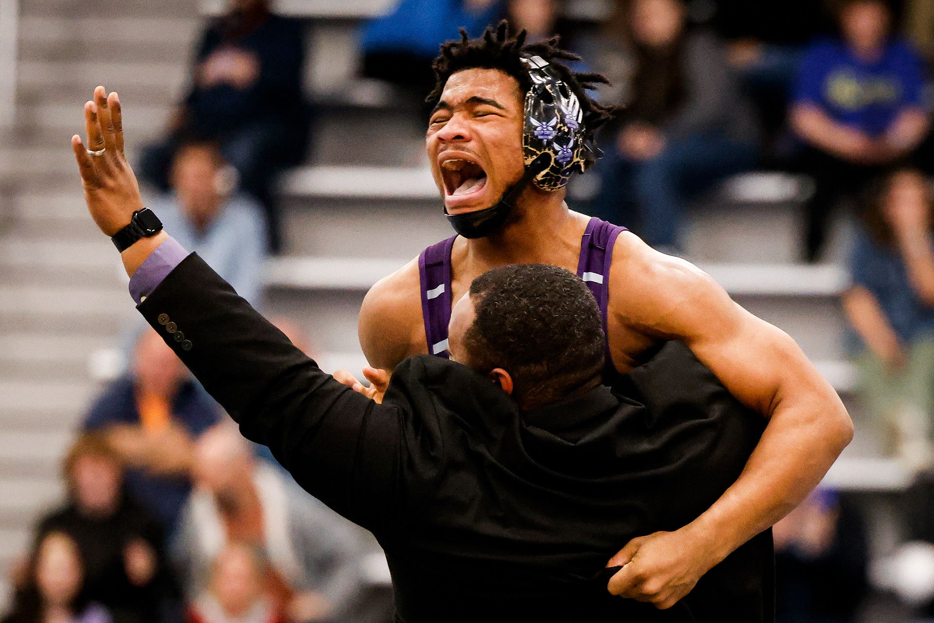 Deep Creek’s Samuel Diggs is hoisted by Deep Creek head coach Travis Ferguson after Diggs pinned his opponent in the final seconds for a come-from-behind victory in the class 6 weight class 175 state championship at the Virginia Beach Sports Center in Virginia Beach, Virginia, on Feb 17, 2024.