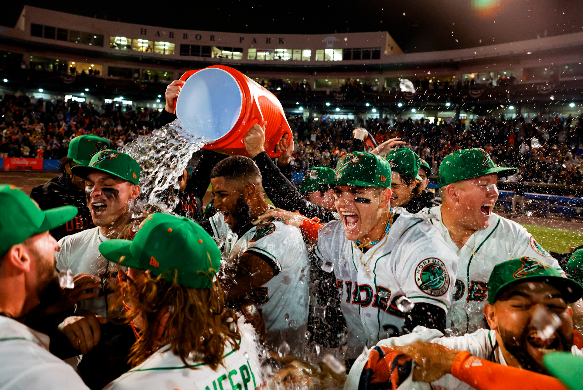 Norfolk tides players celebrate near the pitchers mound after defeating the Durham Bulls 7-0 to win the International League Championship series on Sept. 28, 2023, at Harbor Park in Norfolk, Virginia. The championship is the first for the Tides since 1985, and their first playoff appearance since 2015.