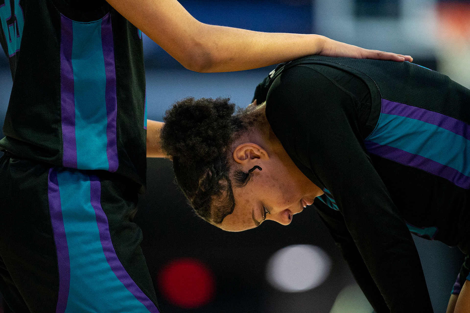 Woodside Aaliyah Carter (11) is comforted by teammate Zaria Richmond (23) after colliding with another player while going for a rebound. Norview defeated Woodside 52-24 in the Class 5 Region B girls semifinals at the Norfolk Scope Arena in Norfolk, Virginia on Feb 22, 2023.