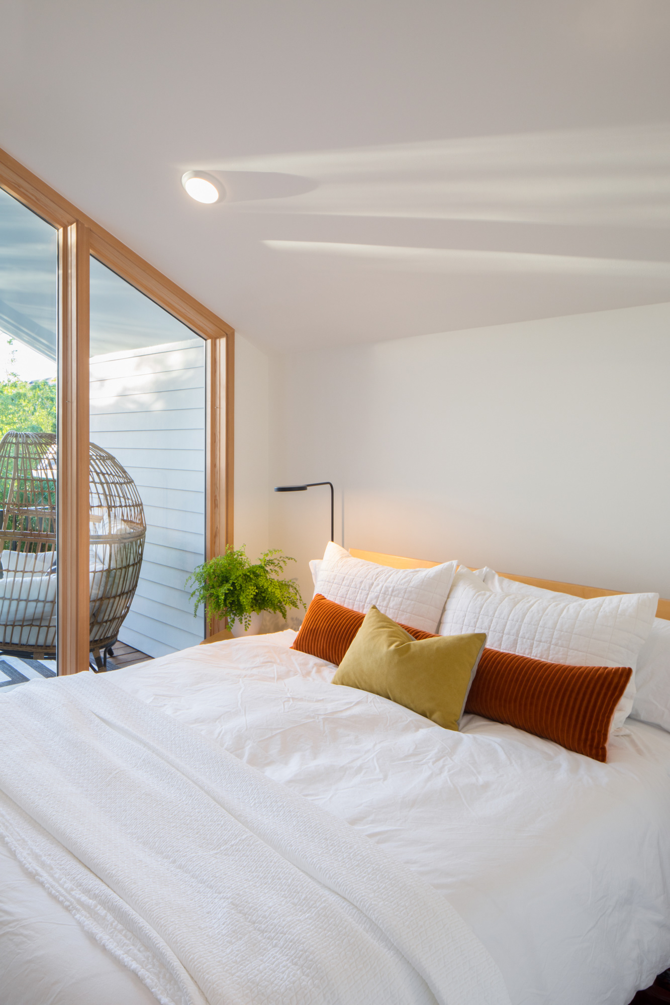 The back bedroom features a cozy king bed and private outdoor terrace.