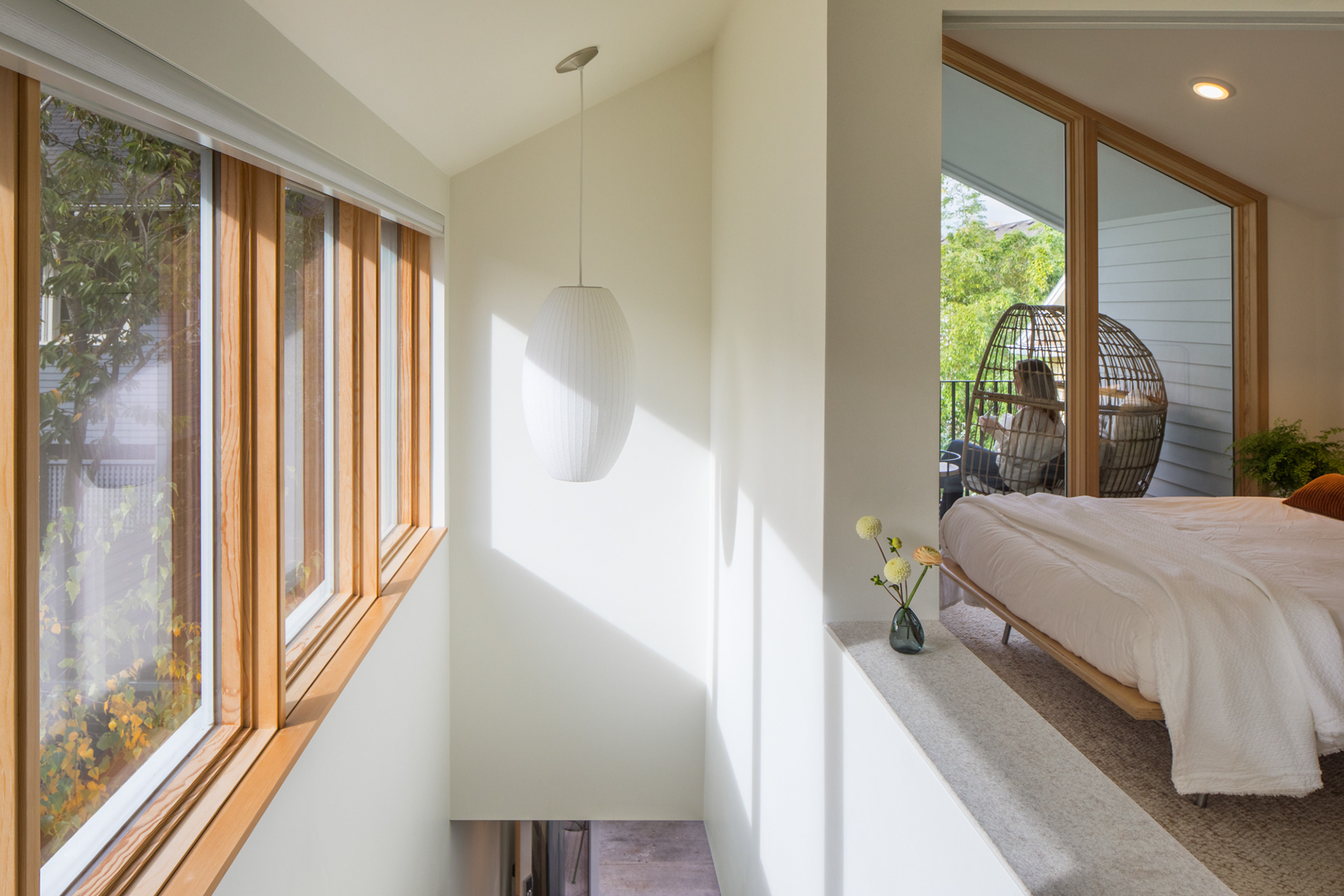 The upstairs spaces feature dramatic sloping ceilings and expansive windows.