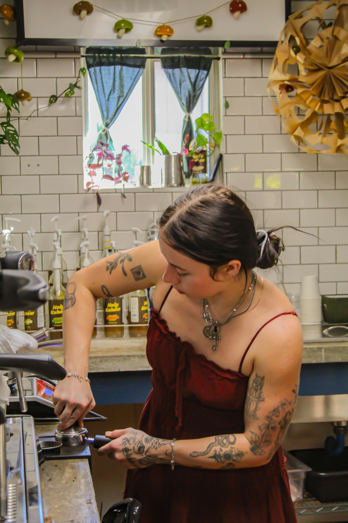 Barista Pressing Coffee at Gaia's Garden Cafe